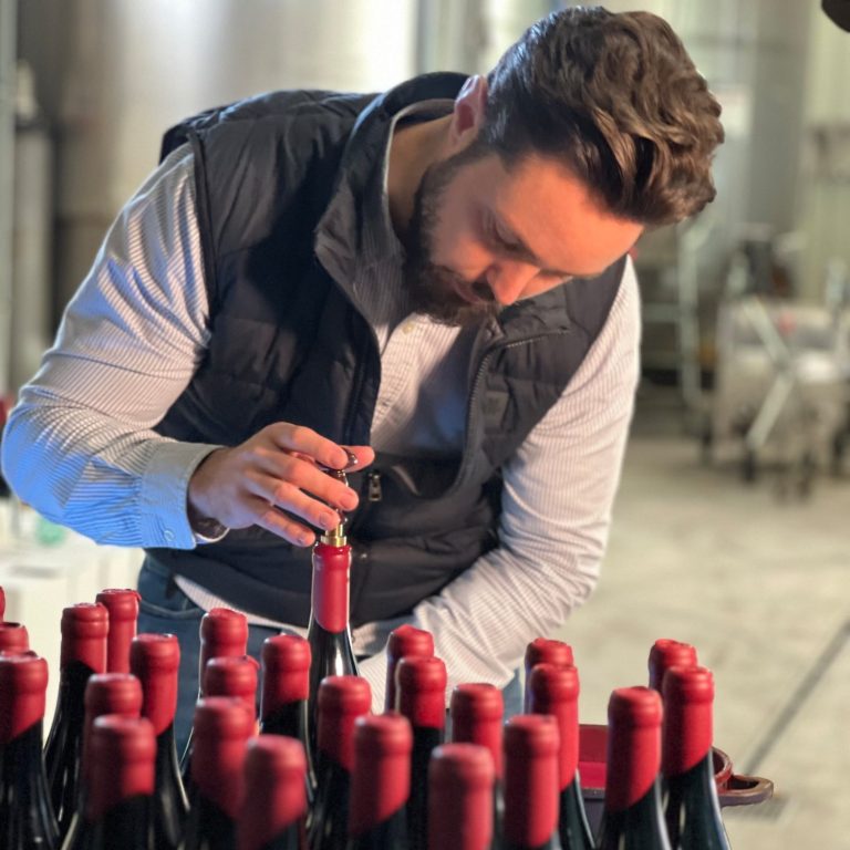 Herstellung des Hypocras: Handarbeit beim Versiegeln der Bio-Würzwein-Flaschen mit Siegelstempel